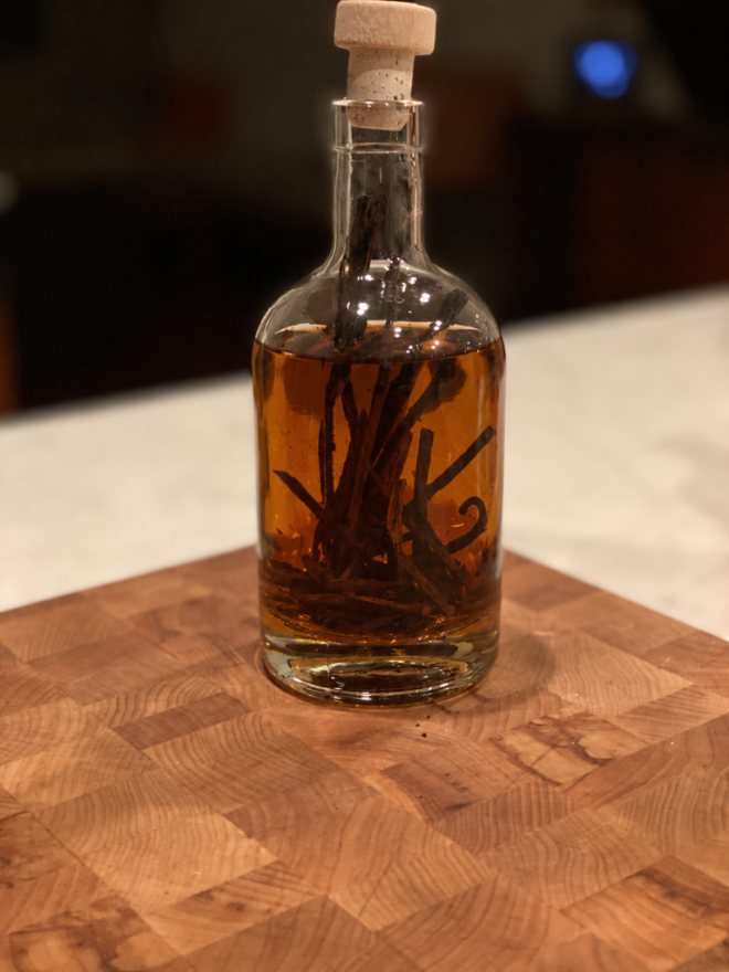 Bottle of homemade vanilla extract with beans in an amber liquid
