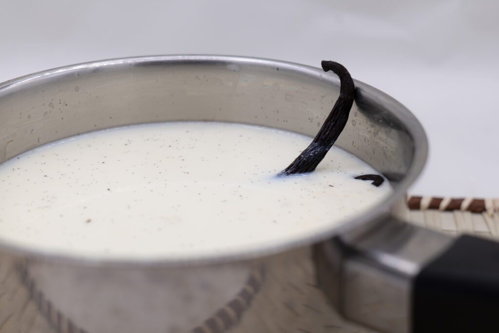 Vanilla bean infusing in hot milk
